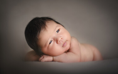 Little cute posing newborn baby boy