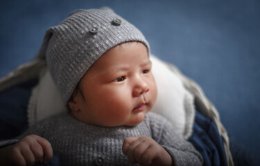 Fototapeta na wymiar Little cute posing newborn baby boy