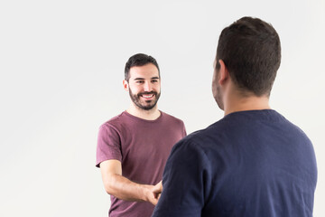 A grateful patient shakes hands with the physiotherapist after a rehabilitation session