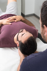 Fototapeta na wymiar Physiotherapist performing a neck massage on a patient