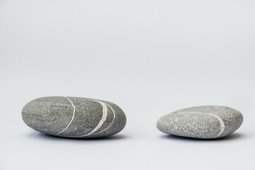 Stones is on the light background, simple poise stones. Purity harmony and Balance Concept. Stone podiums.