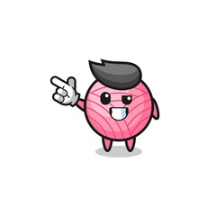 yarn ball mascot pointing top left