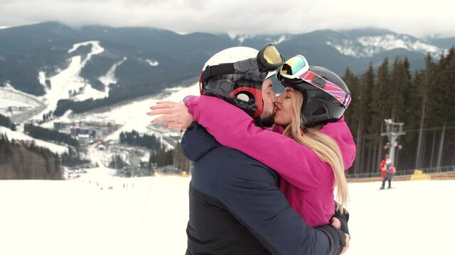 Loving couple in sporty wearing on mountain at ski resort