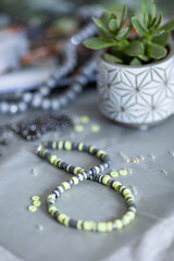 Stylish beads from beads and rubber on a gray background. Fashion accessory for women