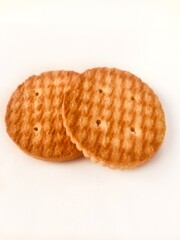 Crispy and savory wheat biscuits on a white plate.