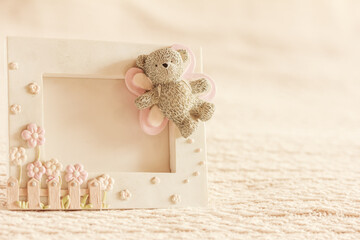 Toy frame for photo with a toy bear on soft beige background, mock up, copy space