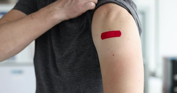 Man points to patch on shoulder after being vaccinated 4k movie