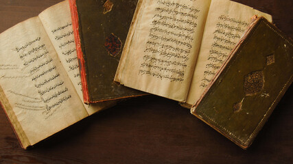 Stack of open ancient books in Arabic. Old Arabic manuscripts and texts. Top view