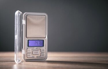 Small digital jewelry scales on the table.
