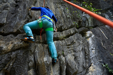 Female rock climber on cliff