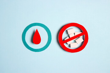 World diabetes day concept with symbol of diabetes and prohibition sign on sugar lumps on blue...
