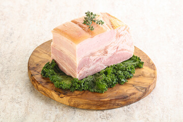 Cut of pork bacon over board