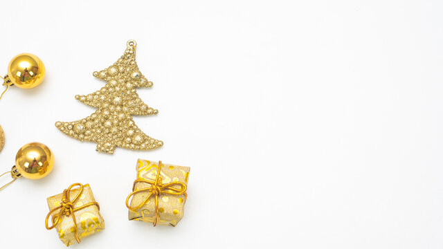 Close up golden christmas accessories on white background top view copy space