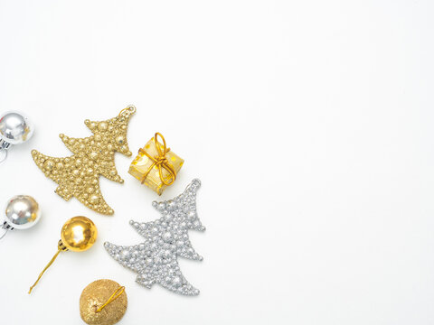 Christmas objects gold and silver top view copy space white background