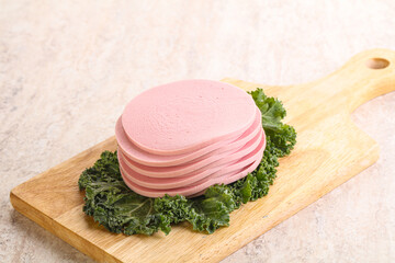 Slices pork sausage over board