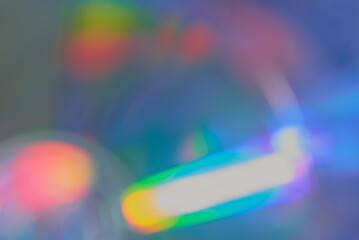 Defocused film texture background with colored lights on dark background. Blurred rainbow color...