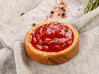 Tomato sauce in the wooden bowl
