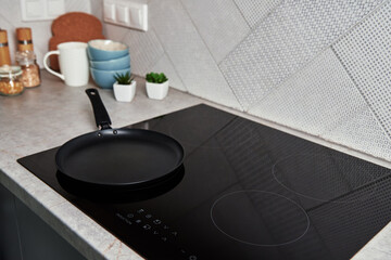Modern kitchen appliance. Cooking pan on the surface of induction panel with sensor panel