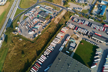 Parking lot for semi trucks, top view. Aerial view of Truck trailers parked for waiting loading on...