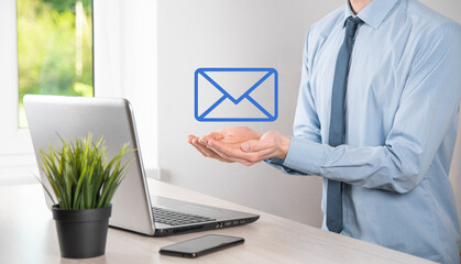 Businessman hand holding e-mail icon, Contact us by newsletter email and protect your personal...