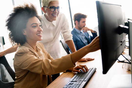 Programmers cooperating at IT company developing apps