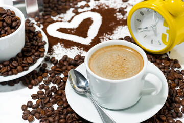 Obraz premium cup of espresso alarm clock and coffee beans conceptual photography, top view