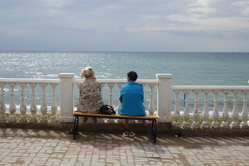 couple sitting by the sea
