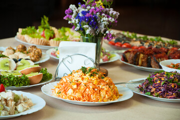table with food. many different salads in the kitchen. festive dinner concept
