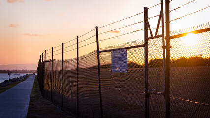 Barbed wire fence, wall of steel. Immigration Prison Criminals or Terrorists security escape concept. 