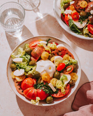 Fresh mediterranean salad with tomatoes and burrata cheese, top view