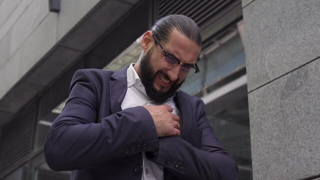 Anxious man touching sore heart, feeling arrhythmia, taking pills to calm down