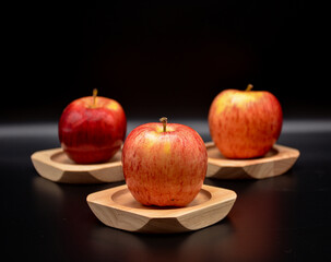 Red Apple on wooden Saucer 