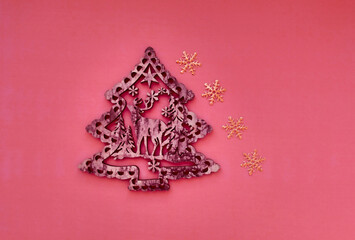 Christmas composition in minimal style with Christmas tree toy and golden snowflake, flat lay, top view