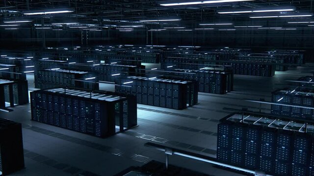 Modern Data Technology Center Server Racks Working in Dark Room. Concept of Internet of Things, Big Data Protection, Storage, Cryptocurrency Farm, Cloud Computing. 3D Moving Back Panning Camera Shot.