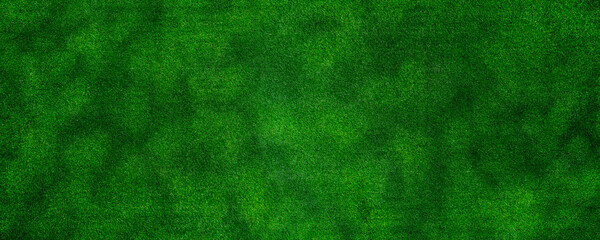 Panorama green artificial grass texture background for decorating the interior or exterior of the garden at home.