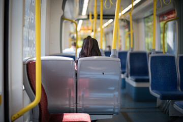 woman behind sitting seat light rail train motion public transport travel explore city commute © LightItUp
