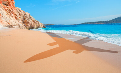 Passenger airplane shadow concept - Travel to exotic destination and airplane flying above beautiful tropical beach and sunny day