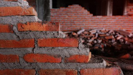 Unconventional building site The masonry was neglected, irresponsible, not progressing, only half finished. Some parts, the walls had rough surfaces.