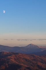 Moon and clouds over the mountains