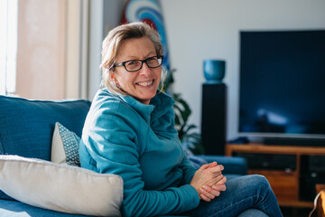 Older woman looking happy smiling in lounge room