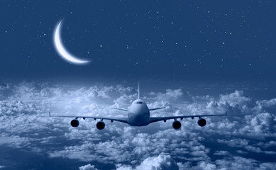 Airplane in the sky with crescent moon © muratart