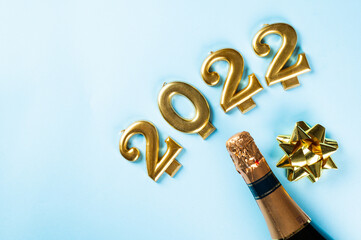 2022 number with champagne bottle and decor. Happy new year and festive concept. Top horizontal...