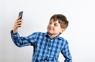 Kid making selfie on smartphone