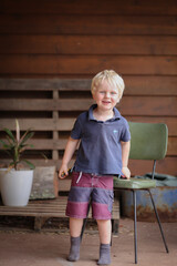 Little cute country boy posing on porch