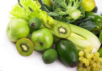 fresh vegetables with leaves - kiwi, grapes, apples and crashes, cucumbers, zucchini, broccoli, cabbage and greens isolated on white background.