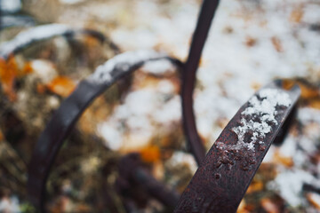 detail of old feather-harrow in the snow at autumn
