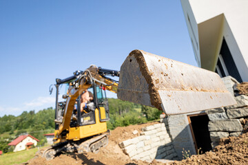 Mini Excavator bucket closeup during work on construction site