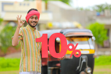 Indian auto driver showing ten percent board with his auto