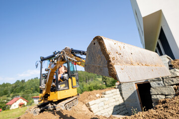 Mini Excavator bucket closeup during work on construction site