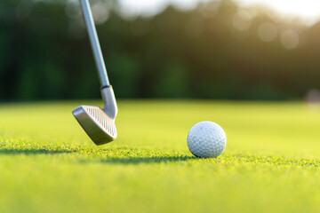 Plakat Golf ball with golf club on green field grass